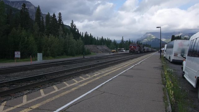 Static shot of stationary freight train at a station in Banff