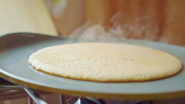 Flapjack, tortilla, pizza, bake fry pancake in pan. A lot of steam. Close up.