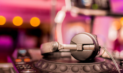 Obraz na płótnie Canvas DJ Spinning, Mixing, and Scratching in a Night Club. DJ playing music at mixer . Closeup. Party.