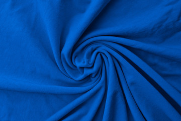 Classic blue delicate fabric draped and spun. Closeup.