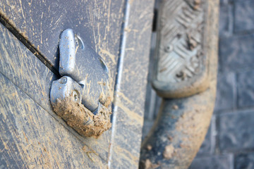 Close up of muddy 4x4 door hinge
