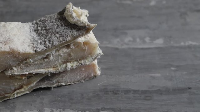 dry cod fish on ceramic background