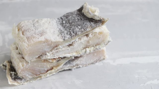 dry cod fish on ceramic background