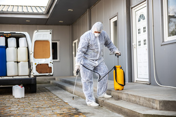 Specialist in hazmat suits cleaning and disinfecting coronavirus cells epidemic, world pandemic health risk.
