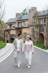 Fototapeta na wymiar An Asian elderly couple walking in the community