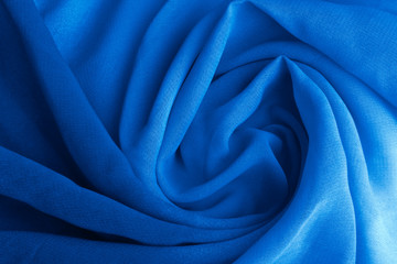 Classic blue delicate fabric draped and spun. Closeup.