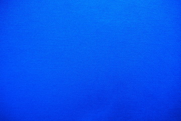 Closeup of beautiful cotton mixed with polyester fabric in bright dark blue tone with rough surface...