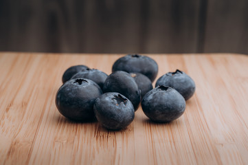 juicy fresh blueberries lay on the wooden table