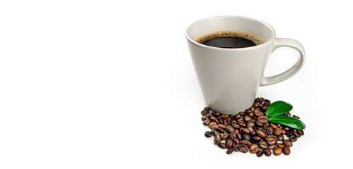 Cup of coffee with beans and green coffee leafs