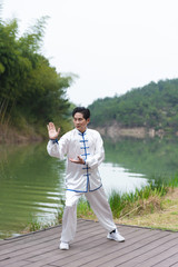 An Asian elderly man doing sports by the lake