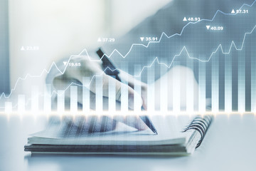 Multi exposure of abstract creative financial graph with hand writing in notepad on background,...