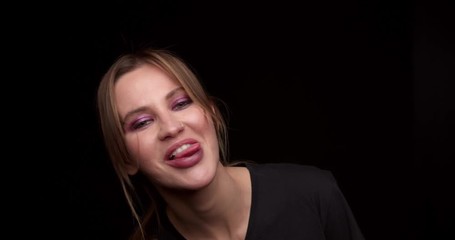 Woman showing his tongue to the camera, fooling around