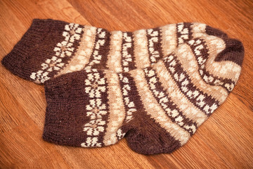 pair of knitted woolen socks lying on the floor