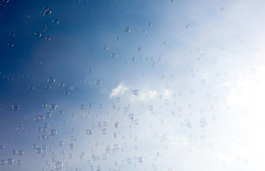 Soap bubbles fly in the blue sky