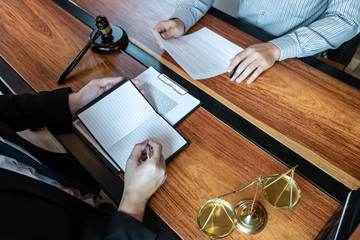 Male lawyer discussing negotiation legal case with client meeting with document contact in courtroom, law and justice concept