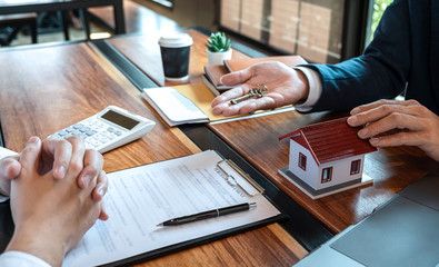 Sale purchase contract to buy a house, Customer sending money buying home loan and giving keys from Agent after signing contract to buy house with approved form, Insurance and Home concept