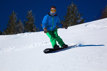 snowboarder on the slope in mountains