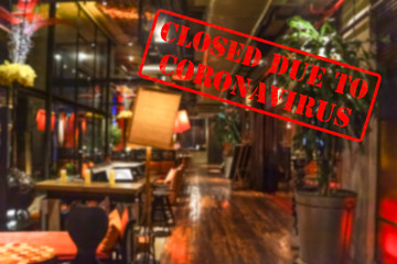 Defocused, blurred view of interior of an upmarket bar or restaurant, empty and closed due to coronavirus or covid 19 pandemics