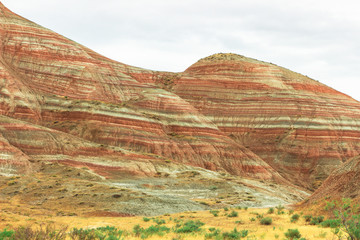 Cross-bedding in Candy Cane Mountains in Azerbaijan. Colorful stripes of the hills. Shale striped mountains. Candyland forest. Red-pink and white striped area of exposed rock