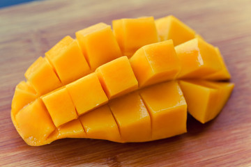 ripe mango on wood background