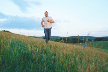 smiling man running in grain field