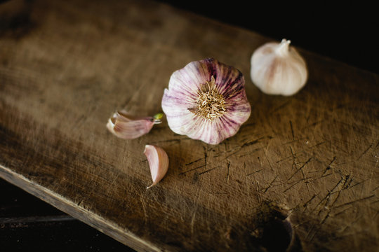 garlic on wooden chopping board.  