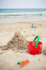 Fototapeta na wymiar sand castle with child bucket
