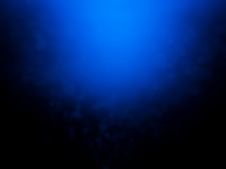 Blue bokeh on a dark background. Blur the background and wallpaper
