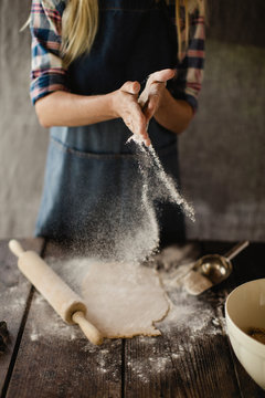 Woman preparing dough for cookies.