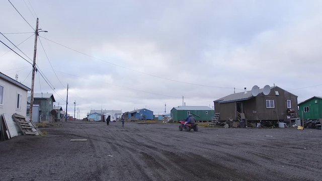 An ATV drving on an empty street in Kivalina Alaska