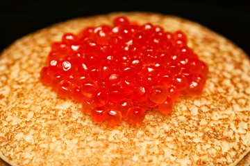 red caviar on the pancake in shrovetide