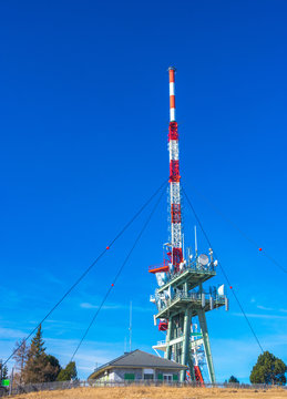 Telecommunication tower with directional mobile phone and internet antennas on Schockl Mountain in St. Radegund, near Graz, Austria. Wireless communication equipment transmitter. 5G Technology.