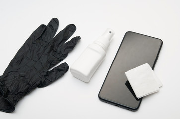 lies an antiseptic, gloves and a phone for disinfection with virus wipes