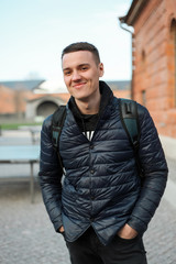 Fototapeta premium Handsome young fashion model posing on city streets. Lifestyle 