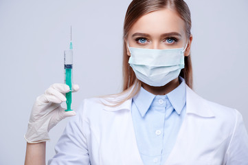 Nurse holding syringe on white isolated background