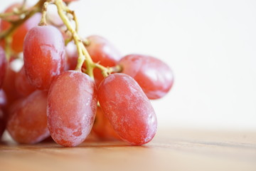 rote Weintrauben-Nahaufnahme und auf einem Küchenbrett