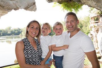 outdoors cheerful family of four in summer park lake aside pond