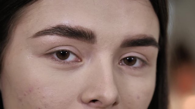 Young brunette looks at the camera