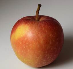 Single red apple closeup with white background