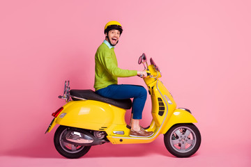 Fototapeta na wymiar Profile side view portrait of his he nice attractive crazy overjoyed glad cheerful cheery guy driving moped having fun traveling isolated over pink pastel color background