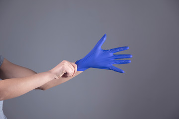 woman hand blue glove