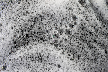 White foam bubbles on a black background