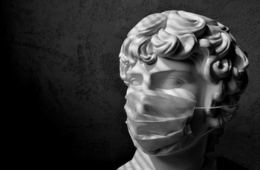 coronavirus. young man in a medical mask - place for text. sculpture in a protective mask is a contemporary art. Kovid-19 in Europe. medical mask - disease prevention