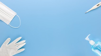 Medical supplies to protect and stay safe from COVID-19 on blue background border design with space for text