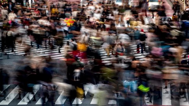 Time lapse high angle view of busy crowd pedestrian people man and woman with tourist walking at shibuya crossing street intersection with transportation traffic at Shibuya, Tokyo metropolis, Japan