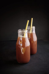 Delicious fragrant hot chocolate in glass jars, with drink tubes