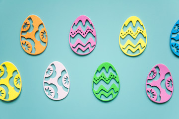 Easter background. Paper easter eggs. Greeting card for the holiday. Multicolored details, bright pastel frame background. A lot of elements.