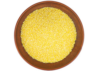 Corn groats in clay bowl isolated on white background