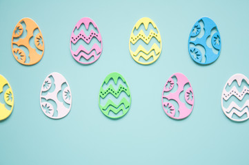 Easter background. Paper easter eggs. Greeting card for the holiday. Multicolored details, bright pastel frame background. A lot of elements.
