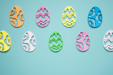 Easter background. Paper easter eggs. Greeting card for the holiday. Multicolored details, bright pastel frame background. A lot of elements.